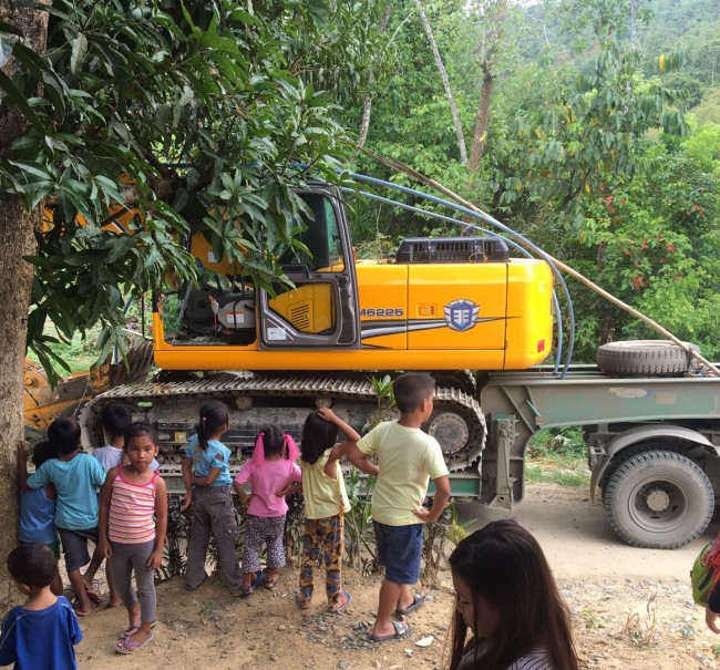 Huge excitement from the children as the back hoe arrives!